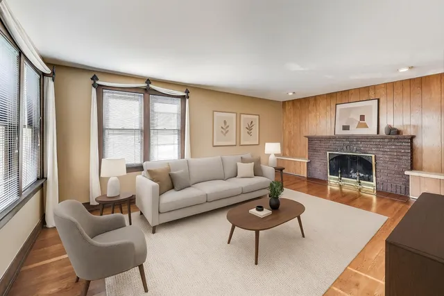 a living room with furniture a rug and a fireplace