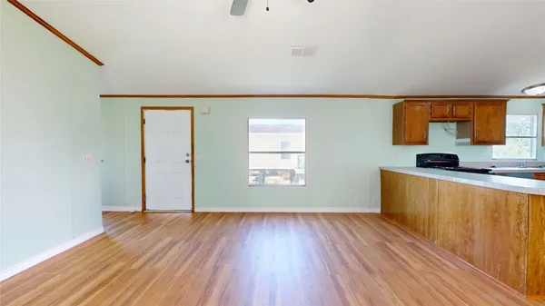 a view of kitchen with wooden floor and electronic appliances