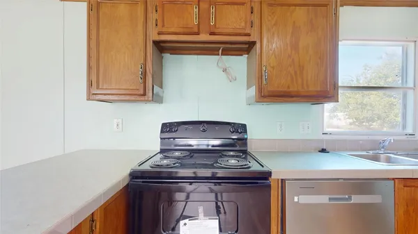 a stove top oven sitting inside of a kitchen
