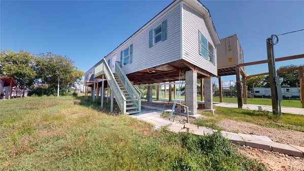 a view of an house with backyard porch and sitting area