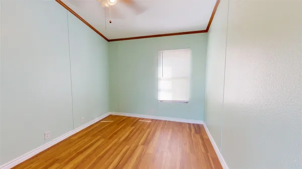 a view of a room with wooden floor and carpet