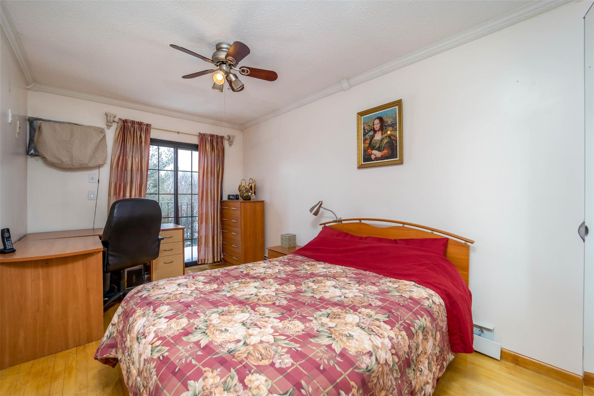 509 Julius Road Queens, NY 11356 - Photo 13 of 26 Bedroom featuring wood finished floors, crown molding, an office area, a ceiling fan, and baseboards