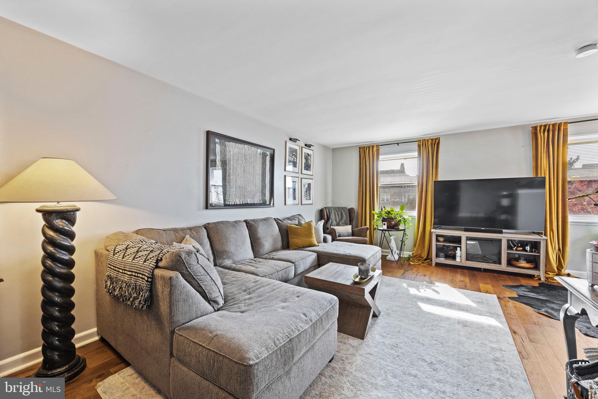 609 Hamilton Street, Unit B Norristown, PA 19401 - Photo 1 of 15 a living room with furniture and a flat screen tv