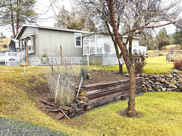 a view of backyard with wooden fence