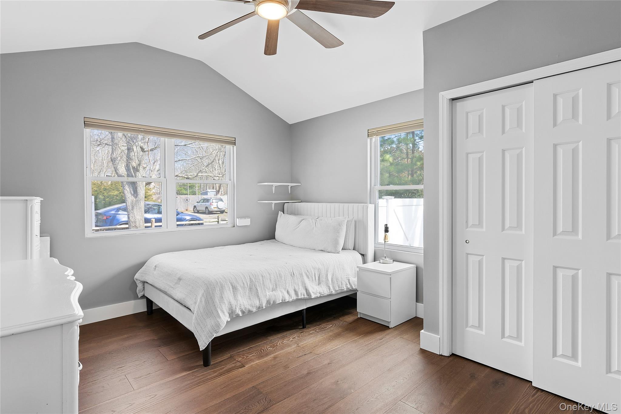 24 Woodridge Road Hampton Bays, NY 11946 - Photo 9 of 18 a bedroom with a large bed and a window