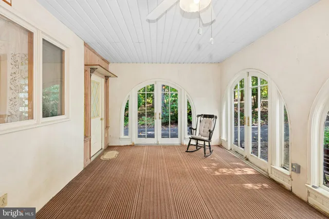 a view of a room with wooden floor and furniture