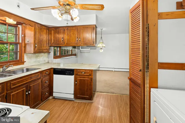 a bathroom with a granite countertop sink a mirror and a shower