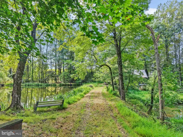 a backyard of a house with lots of green space and fountain