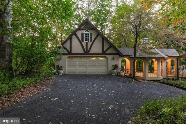 a view of a house with a yard and tree s