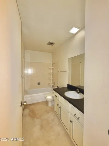 a large bathroom with a tub a sink and a large mirror