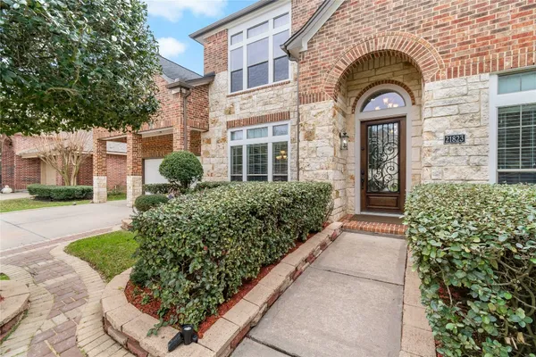 a view of a brick house with a large windows