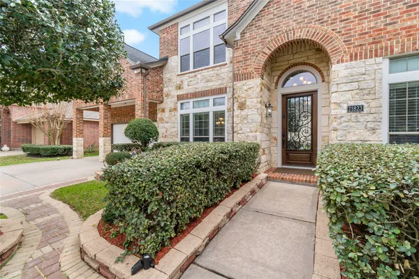 a view of a brick house with a large windows
