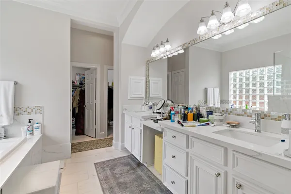 a bathroom with a double vanity sink mirror and double
