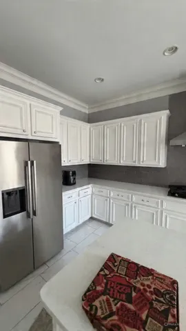 a kitchen with stainless steel appliances granite countertop a refrigerator sink and cabinets