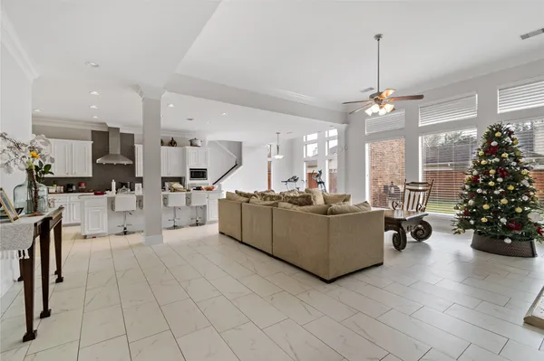 a living room with furniture and a chandelier