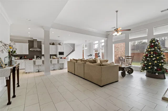 a living room with furniture and a chandelier