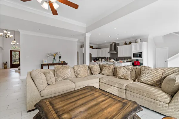 a living room with furniture and kitchen view