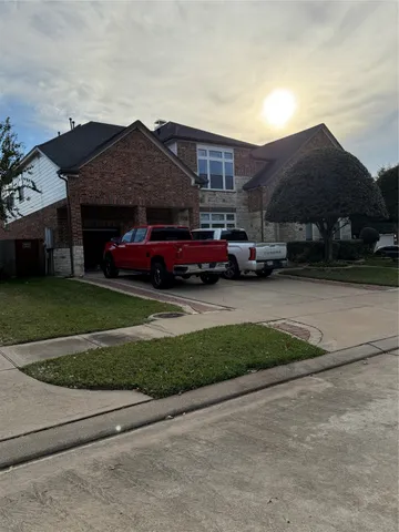 a red car parked in front of a house