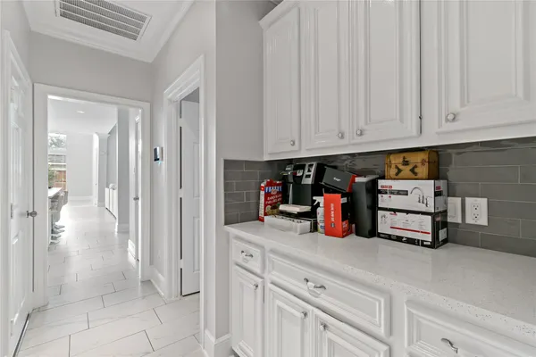a kitchen with white cabinets and white appliances