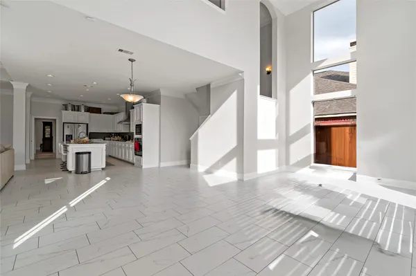 a view of a kitchen with furniture and an empty room