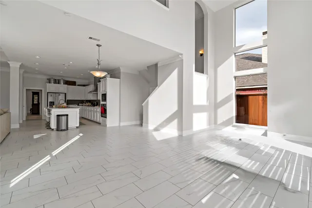 a view of a kitchen with furniture and an empty room