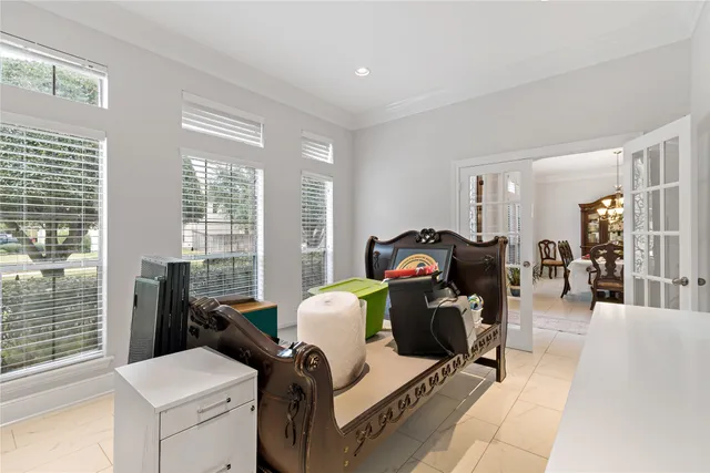 a view of a workspace with furniture and a window