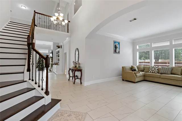 a living room with furniture and a chandelier