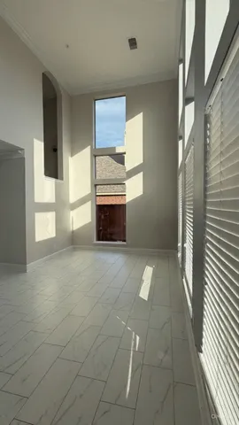 a view of empty room with a fireplace