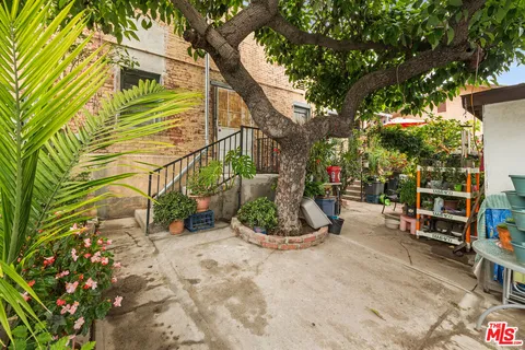 a view of a chair and table in the backyard