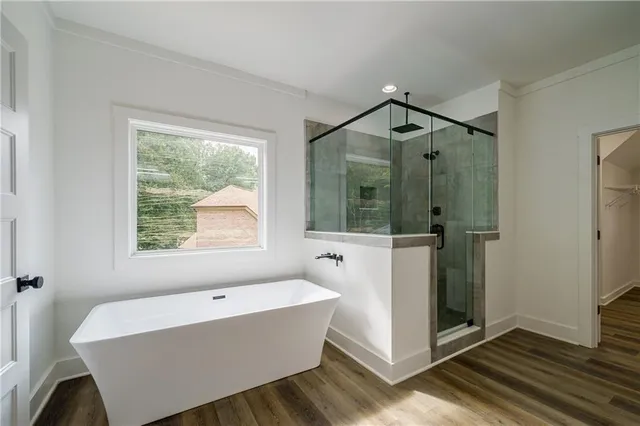 a bathroom with a bathtub and a shower