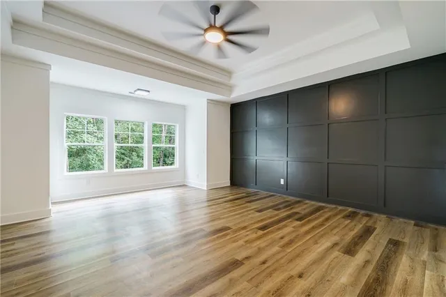 a view of a livingroom with a chandelier fan and a window