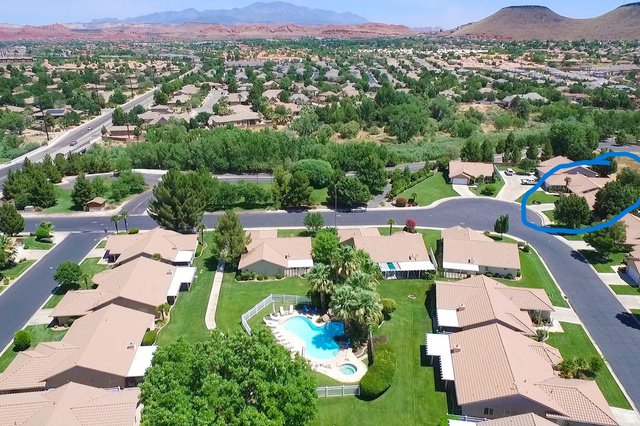1825 West Mathis Park Place, Unit 40 St. George, UT 84770 - Photo 28 of 28 Aerial view of residential area with a mountainous background and a pool area