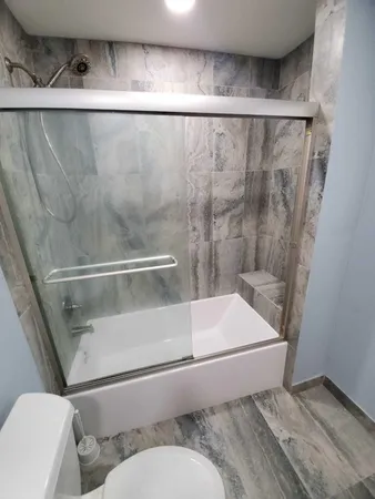 a bathroom with a toilet and a shower