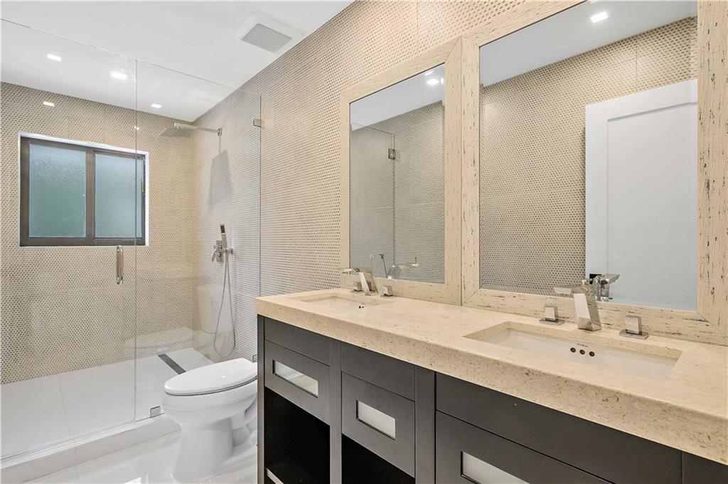 2201 Intracoastal Drive Fort Lauderdale, FL 33305 - Photo 27 of 35 a bathroom with a double vanity sink toilet and shower
