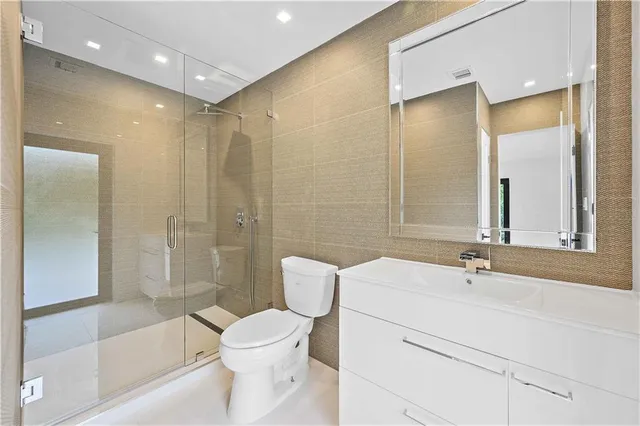 a bathroom with a sink mirror and window