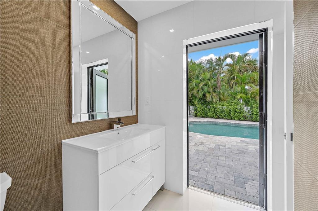 2201 Intracoastal Drive Fort Lauderdale, FL 33305 - Photo 29 of 35 a bathroom with a sink mirror and window