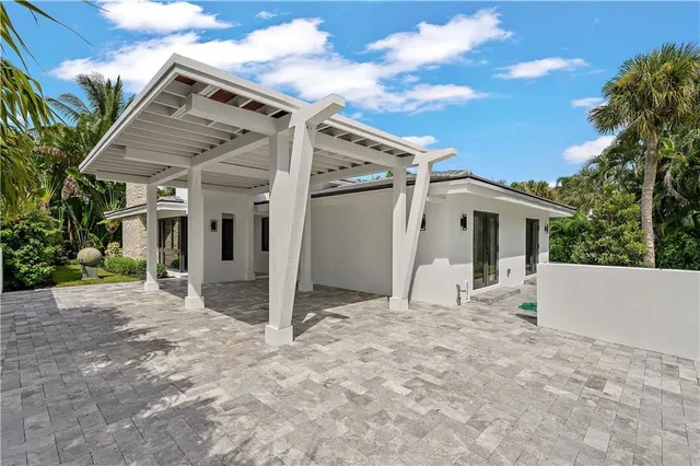 a front view of a house with swimming pool having outdoor seating