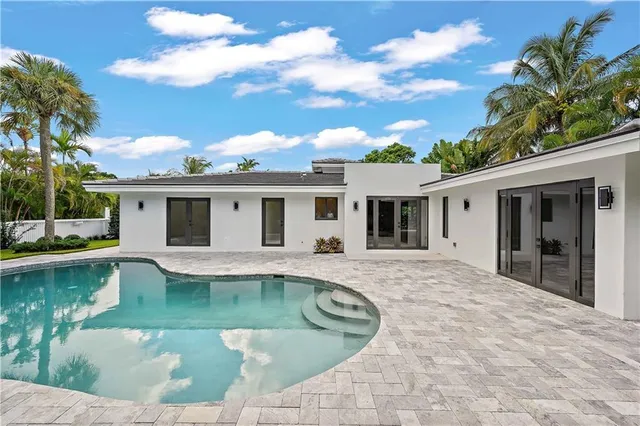 a front view of a house with swimming pool having outdoor seating