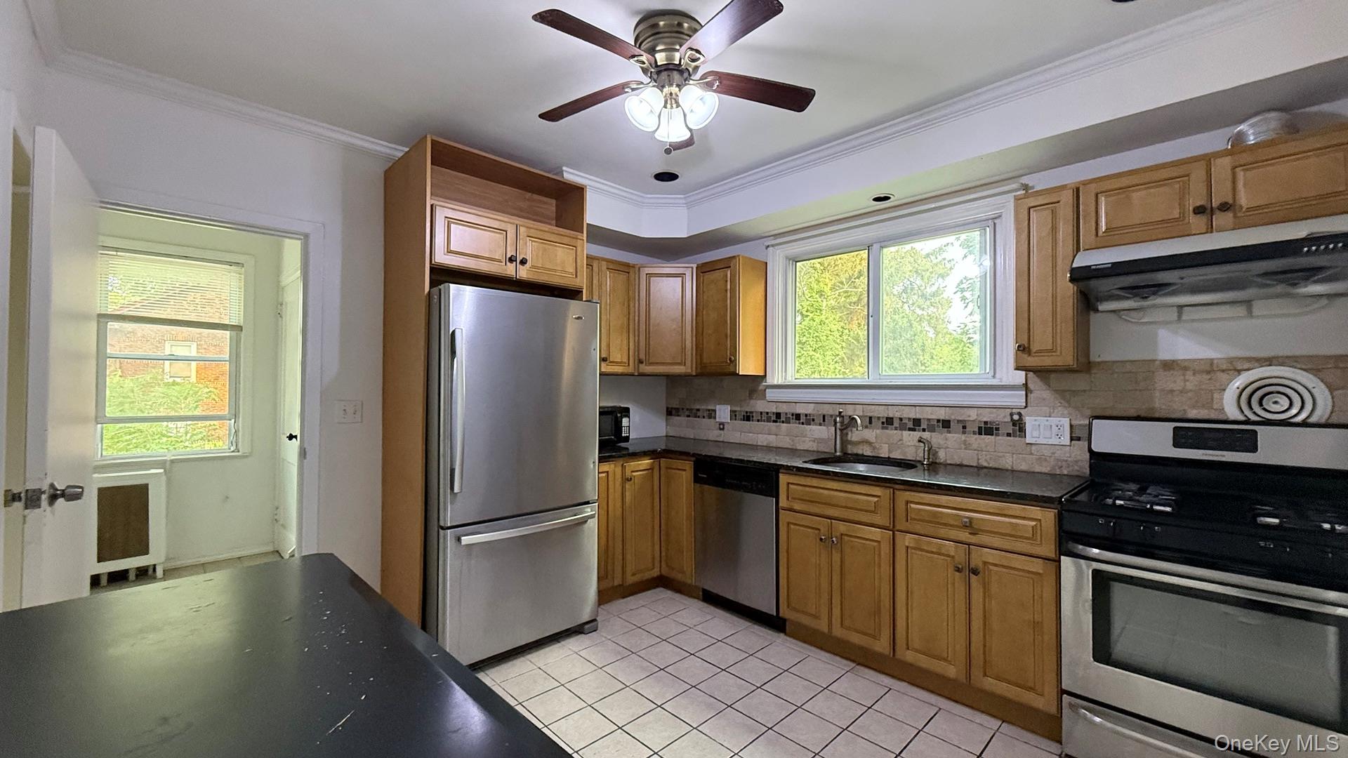 15 Prospect Street, Unit 2 Great Neck, NY 11021 - Photo 6 of 11 a kitchen with stainless steel appliances granite countertop a stove refrigerator and a sink