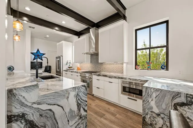a large white kitchen with lots of counter top space