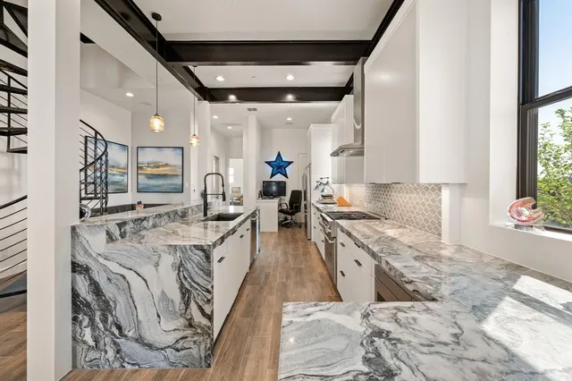 a kitchen with stainless steel appliances granite countertop a sink stove and cabinets