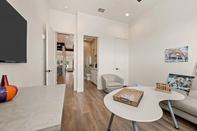 a living room with furniture and a wooden floor