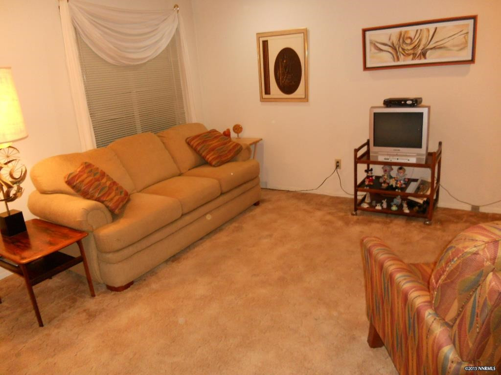 6510 Flower Street Reno, NV 89506 - Photo 1 of 1 a living room with furniture and a flat screen tv