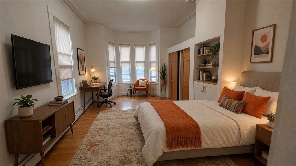 124 Marcella Street, Unit 1 Boston, MA 02119 - Photo 5 of 13 a bedroom with bed tv and window