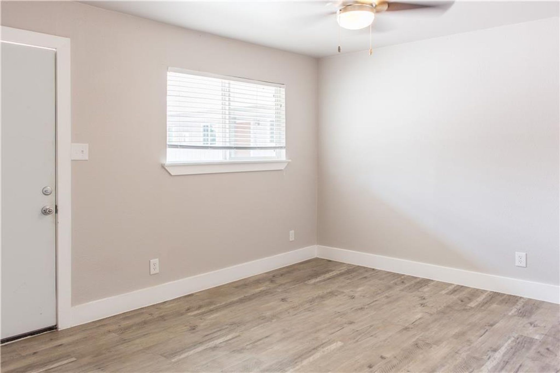 1302 East 52nd Street, Unit 101 Austin, TX 78723 - Photo 2 of 8 an empty room with wooden floor and windows