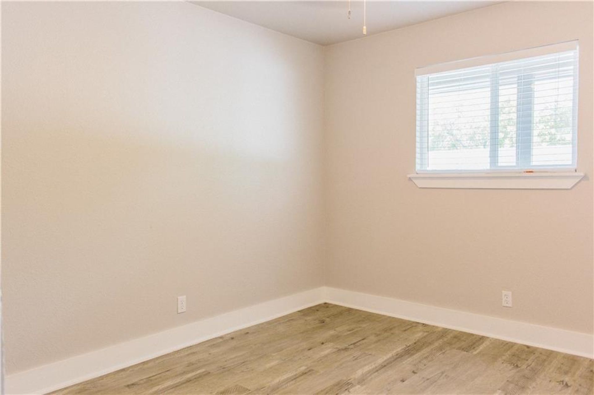 1302 East 52nd Street, Unit 101 Austin, TX 78723 - Photo 5 of 8 an empty room with wooden floor and windows