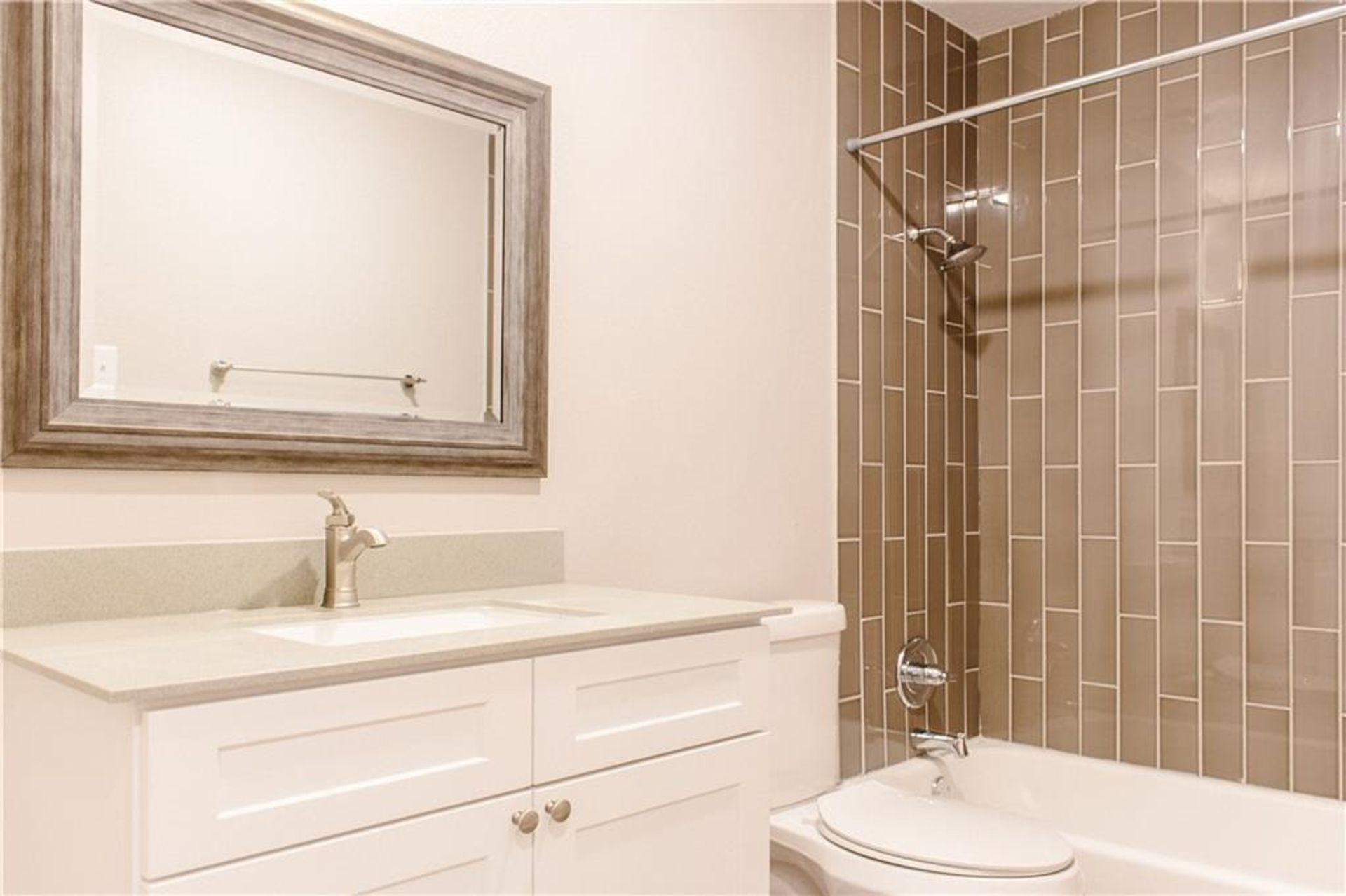 1302 East 52nd Street, Unit 101 Austin, TX 78723 - Photo 6 of 8 a bathroom with a sink toilet and shower