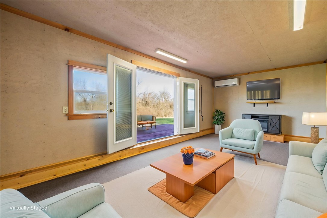10797 Gratis Jacksonburg Road Somerville, OH 45064 - Photo 24 of 27 This bright living space opens directly to the outdoors, seamlessly blending indoor comfort with nature's tranquility.