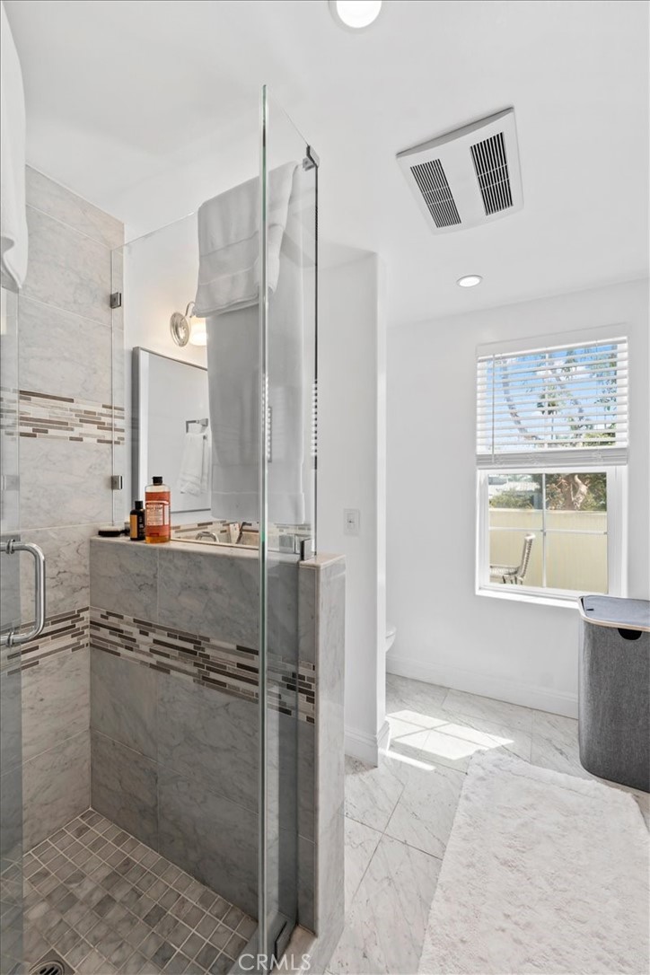 1020 Harbor Crossing Lane Marina del Rey, CA 90292 - Photo 42 of 54 a bathroom with a granite countertop sink a large mirror and shower