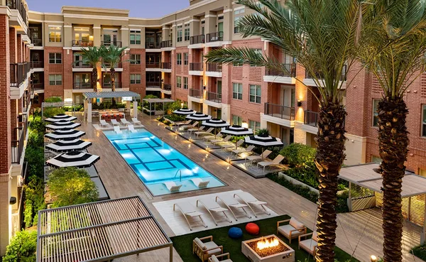 a view of swimming pool with a patio and garden
